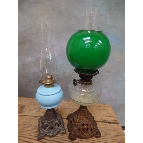 211 - TWO ANTIQUE OIL LAMPS, ONE WITH A WRYTHEN GLASS FONT, ON ORNATE CAST IRON BASE, WITH DUPLEX BURNERS,... 