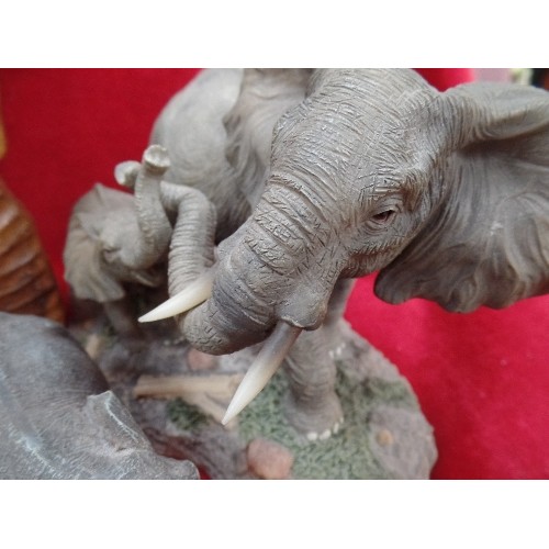 169 - A COLLECTION OF 9 ELEPHANTS, IN WOOD AND RESIN, THE LARGEST 27CM