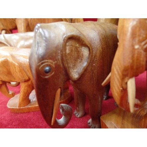 169 - A COLLECTION OF 9 ELEPHANTS, IN WOOD AND RESIN, THE LARGEST 27CM