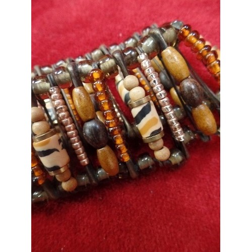 46C - ETHNIC BEADED BRACELET OF GLASS WOOD AND METAL HELD TOGETHER WITH SAFETY PINS AS PART OF THE DESIGN