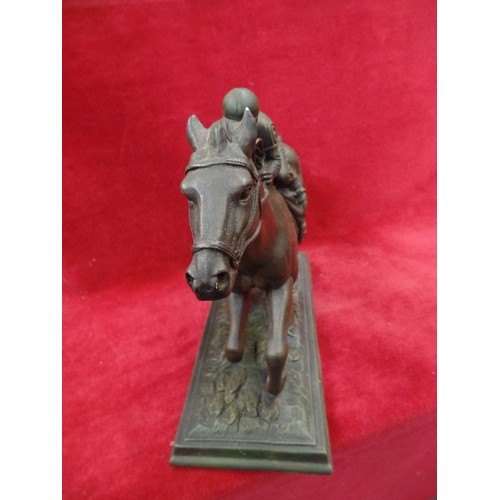 123 - A BRONZE EFFECT RESIN SCULPTURE OF A RACEHORSE 