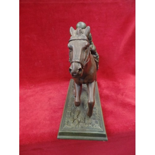 125 - A BRONZE EFFECT RESIN SCULPTURE OF A RACEHORSE 