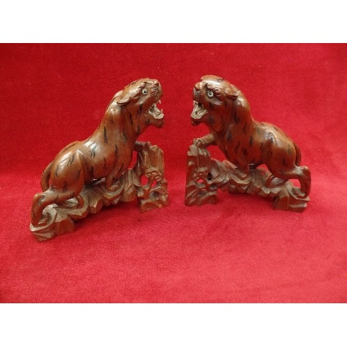 138 - A PAIR OF MID CENTURY CHINESE CARVED HARDWOOD TIGERS AND A CHINESE CARVED HARDWOOD FIGURE OF A SCRIB... 