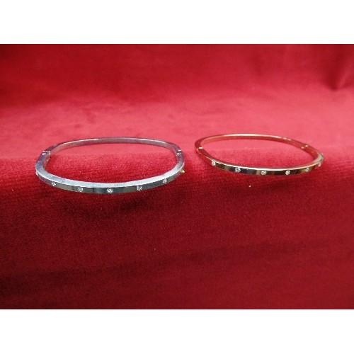 43 - PAIR OF MATCHING BRACELETS WITH WHITE STONES, ONE IN GOLD, THE OTHER SILVER PLATE