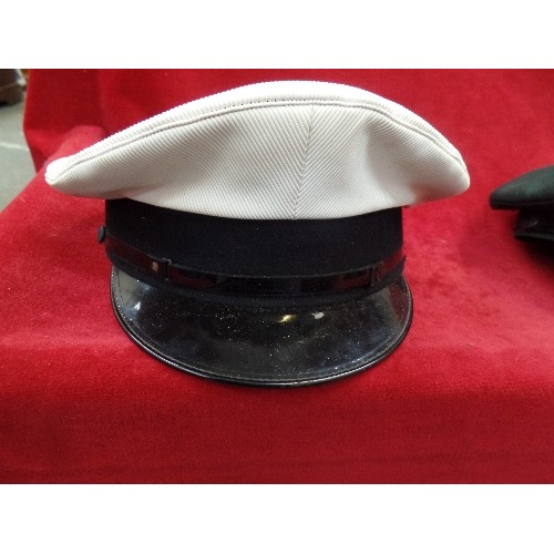 90B - 4 X VINTAGE MILITARY DRESS HATS. 2 ARE NAVY/BLACK WITH RED PIPING, A DARK GREEN, AND A WHITE WITH BL... 