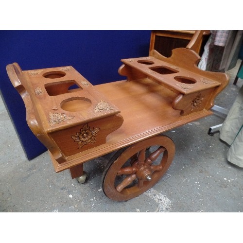 261B - RETRO-KITSCH DRINKS TROLLEY IN TEAK. CARVED FLOWERS. PULL-ALONG BARROW HANDLE.