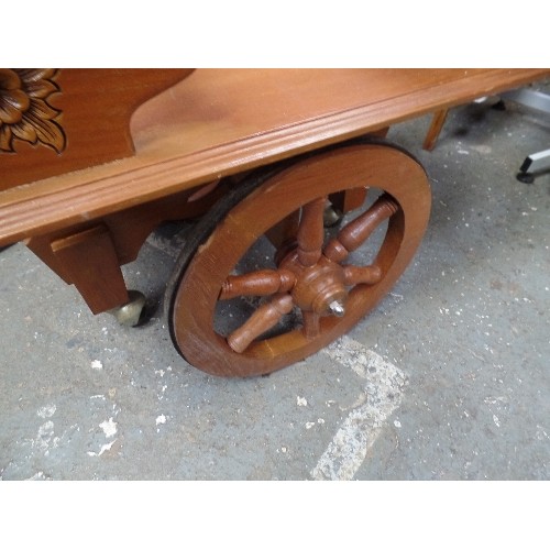 261B - RETRO-KITSCH DRINKS TROLLEY IN TEAK. CARVED FLOWERS. PULL-ALONG BARROW HANDLE.