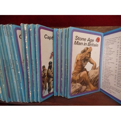 319D - COLLECTION OF 35 LADYBIRD HISTORY BOOKS - 1960's AND 70's IN A VINTAGE SOLID OAK BOOKSTAND