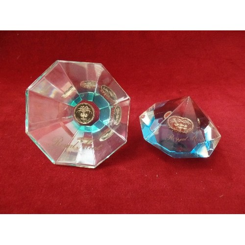 76 - 2 X ROYAL MINT FACETED GLASS PAPERWEIGHTS. EACH WITH A £1 COIN.