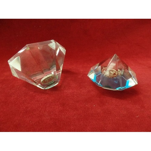 76 - 2 X ROYAL MINT FACETED GLASS PAPERWEIGHTS. EACH WITH A £1 COIN.