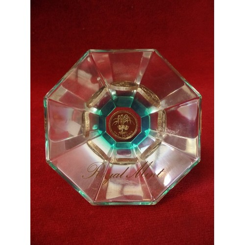 76 - 2 X ROYAL MINT FACETED GLASS PAPERWEIGHTS. EACH WITH A £1 COIN.