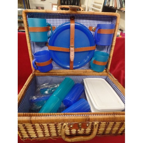 252 - WICKER PICNIC BASKET, COMPLETE WITH PLASTIC BEAKERS, PLATES, CUTLERY AND SANDWICH TUBS.