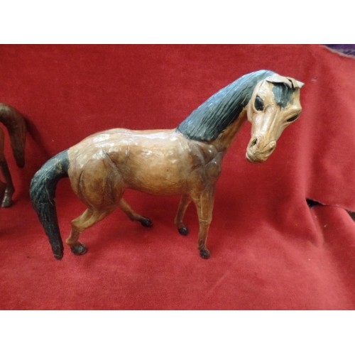 314 - 2 BEAUTIFUL HAND-MADE LEATHER HORSES. TALLEST 29CM H. 1 HAS LEATHER SADDLE, BRIDLE ETC.