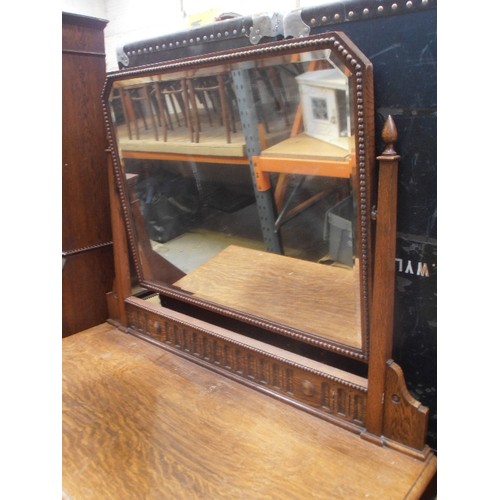 527 - 1920'S OAK DRESSING TABLE WITH TWO OVER TWO DRAWERS AND LARGE SWIVEL MIRROR WITH BEVELLED GLASS - ON... 