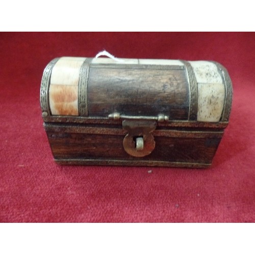 27 - INDIAN WOODEN DECORATIVE TRINKET BOX IN SHAPE OF TREASURE CHEST WITH CONTENTS OF BELLY BUTTON BARS