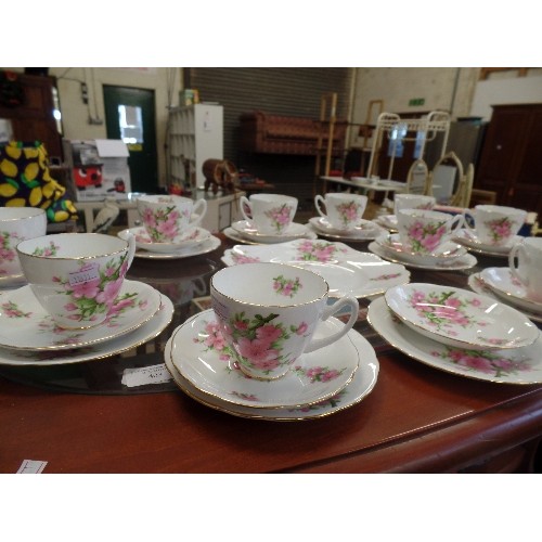 404 - PRETTY VINTAGE TEA SET. 11 X TRIOS [1 CUP MISSING] CAKE PLATE. PINK FLOWERS AND GOLD TRIM.