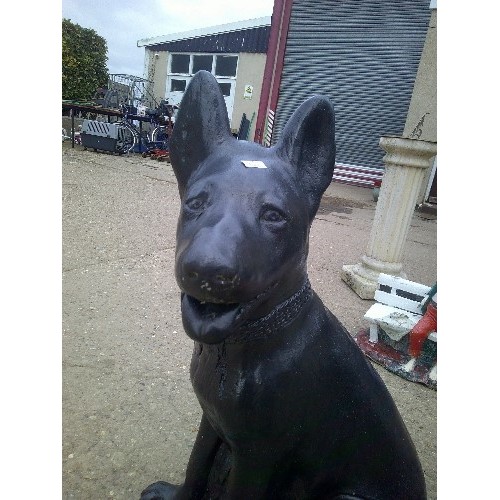 629 - HEAVY LARGE CONCRETE GARDEN ORNAMENT OF A ALSATION PUPPY PAINTED BLACK 63CM OR 2`1