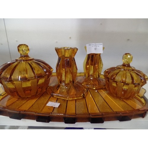 87 - VINTAGE AMBER GLASS DRESSING TABLE SET. PAIR OF CANDLESTICKS, 2 LIDDED POTS, ON A MATCHING TRAY.