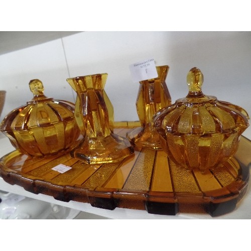 87 - VINTAGE AMBER GLASS DRESSING TABLE SET. PAIR OF CANDLESTICKS, 2 LIDDED POTS, ON A MATCHING TRAY.