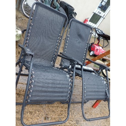 574 - PAIR OF BLACK METAL FOLDING SUNLOUNGERS