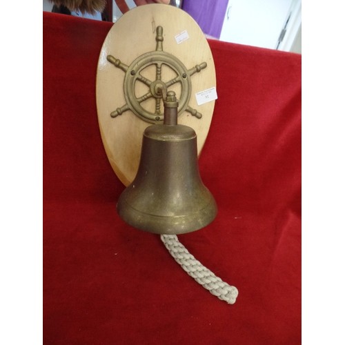 91 - DECORATIVE SHIPS BELL, SHIPS WHEEL. BRASS ITEMS ON A WOODEN MOUNT.