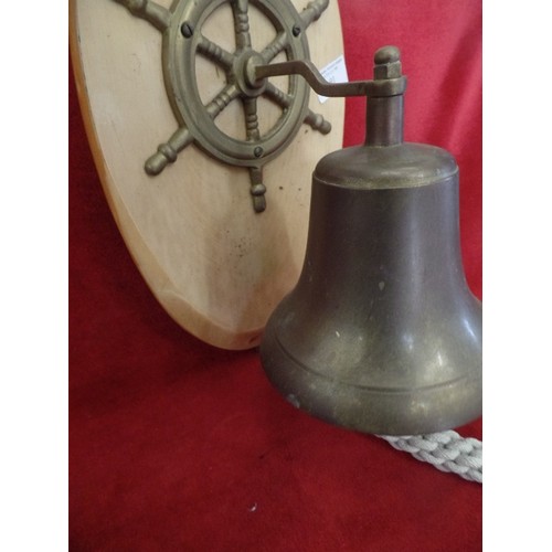 91 - DECORATIVE SHIPS BELL, SHIPS WHEEL. BRASS ITEMS ON A WOODEN MOUNT.