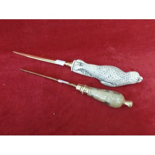 117 - 2 ATTRACTIVE LETTER OPENERS. INC A BABY SEAL, & A HEAVY FLORAL CERAMIC.