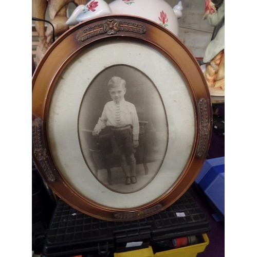 209 - A PAIR OF VINTAGE OVAL FRAMES CONTAINING SEPIA PHOTOGRAPHS. ONE OF A YOUNG BOY, THE OTHER IS SAME BO... 