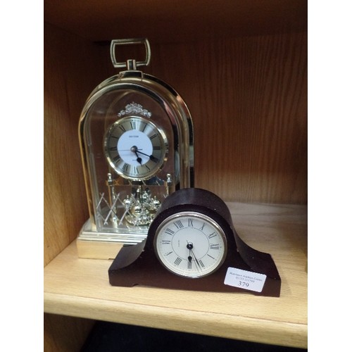 379 - A 'BRASS EFFECT' CARRIAGE CLOCK, AND A SMALL NELSONS HAT MANTEL CLOCK.