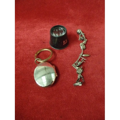 27 - SILVER METAL BRACELET AND CHARMS, SILVER METAL LARGE LOCKET PENDANT AND JEWELLERS LOUPE