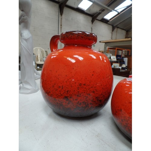 187 - TWO 1960'S WEST GERMAN LAVA VASES IN BRIGHT ORANGE, THE LARGER ONE WITH A HANDLE, NO 484-27