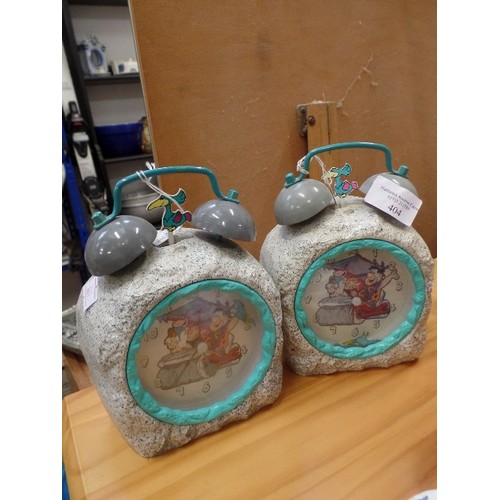 404 - A PAIR OF FLINTSTONES ALARM CLOCKS. RESEMBLE ROCKS. TRADITIONAL WITH BELLS ON.