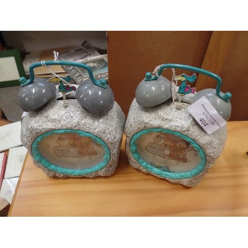 404 - A PAIR OF FLINTSTONES ALARM CLOCKS. RESEMBLE ROCKS. TRADITIONAL WITH BELLS ON.