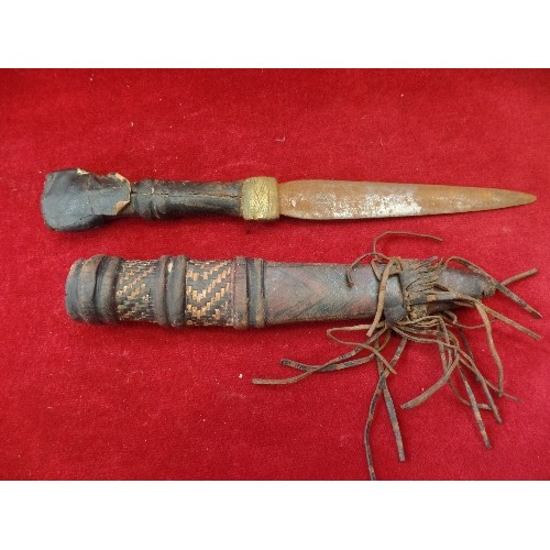 165 - AN EARLY 20TH CENTURY AFRICAN DAGGER WITH LEATHER COVERED GRIP. GOOD LEATHER SHEATH WITH TOOLED LEAT... 