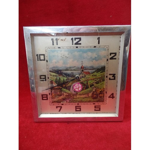 289 - AN UNUSUAL 1950'S CHROME FRAMED CLOCK WITH ALPINE SCENE AND TURNING WATERWHEEL - 18CM SQUARE - WITH ... 