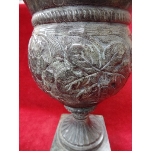 163 - PATINATED BRASS URN WITH GRAPE VINE DESIGN. THE TOP SECTION IN PRESSED BRASS, THE BASE HEAVY SOLID B... 