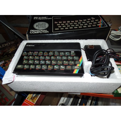 384 - A SINCLAIR ZX SPECTRUM PERSONAL COMPUTER WITH LEADS AND POWER SUPPLY WITH ORIGINAL BOX TOGETHER WITH... 