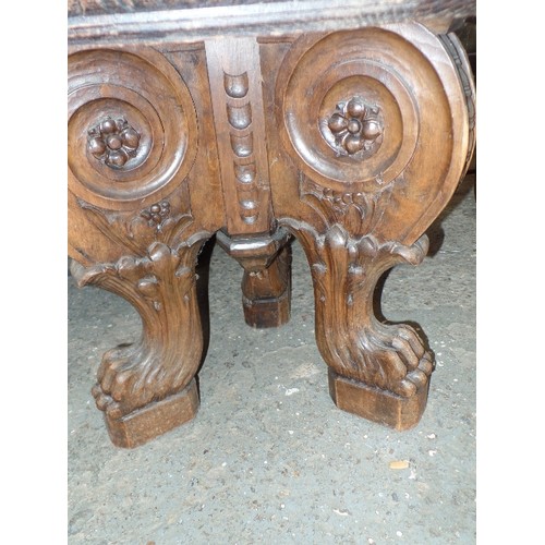 453 - A MARBLE TOPPED CENTRE TABLE, THE TRIPOD BASE HEAVILY CARVED WITH SCROLLS AND VINES, TERMINATING IN ... 