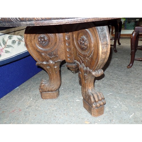 453 - A MARBLE TOPPED CENTRE TABLE, THE TRIPOD BASE HEAVILY CARVED WITH SCROLLS AND VINES, TERMINATING IN ... 