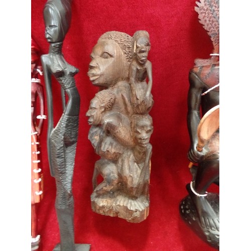 143 - A GROUP OF AFRICAN CARVED WOODEN FIGURES, THREE OF THEM WITH BEADED DECORATION