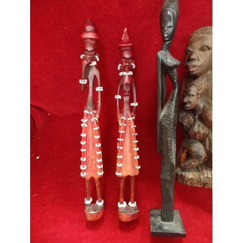 143 - A GROUP OF AFRICAN CARVED WOODEN FIGURES, THREE OF THEM WITH BEADED DECORATION