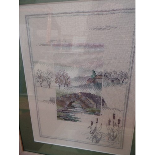 123 - THREE FINELY WORKED CROSS STITCH EMBROIDERY PICTURES, A PAIR OF LANDSCAPES IN PALE GREYS AND GREENS ... 