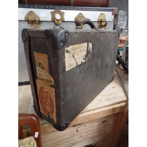 372A - CIRCA 1930'S GREY SUITCASE WITH LEATHER HANDLE - GOOD LUGGAGE LABELS 