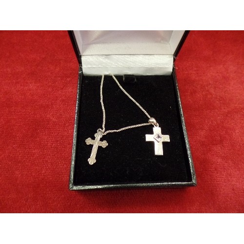 74 - A 925 SILVER CROSS AND CHAIN. ONE CROSS SET WITH AN AMETHYST COLOUR STONE