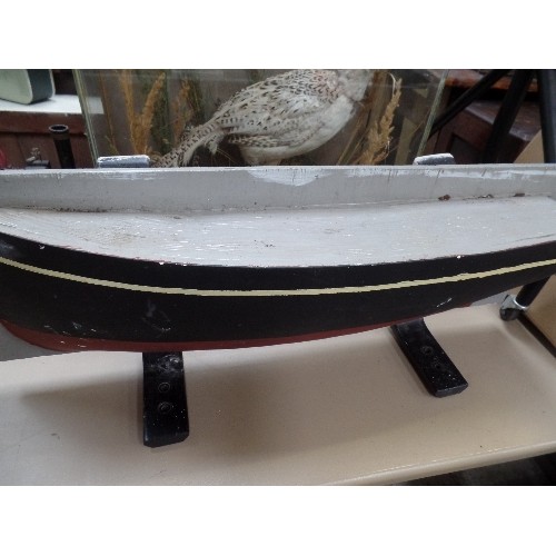 305 - A HEAVY WOODEN MODEL OF A SHIPS HULL ON CAST IRON BRACKETS