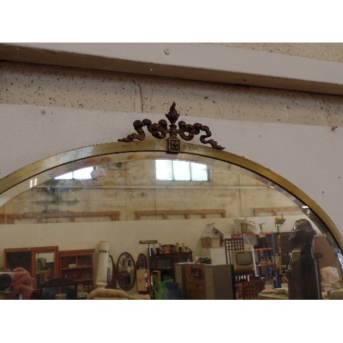 213 - LARGE BRASS/METAL OVAL BEVELLED WALL MIRROR.