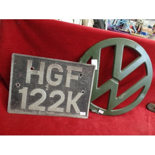 448 - METAL VW LOGO. AND A VINTAGE CAR SQUARE REG PLATE.