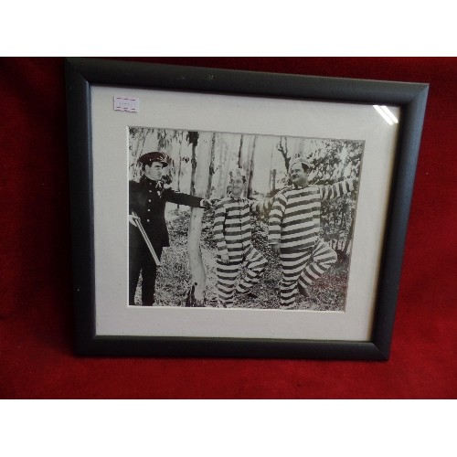 450 - FRAMED GLAZED LAUREL AND HARDY PHOTOGRAPH.