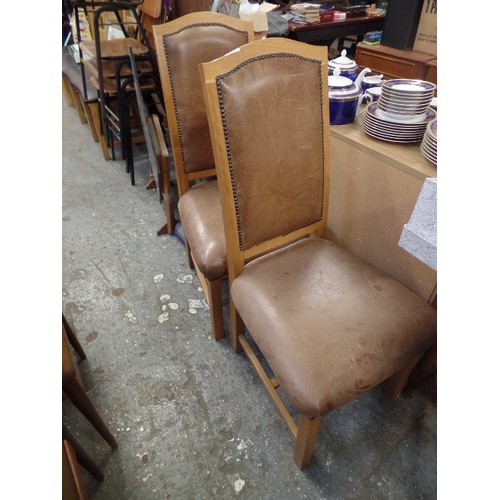 665 - PAIR OF OAK FRAMED AND BROWN DISTRESSED LEATHER DINING CHAIRS. WITH STUDDED DETAIL.