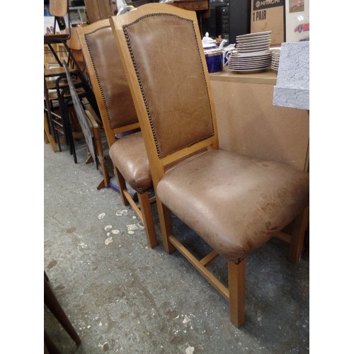 665 - PAIR OF OAK FRAMED AND BROWN DISTRESSED LEATHER DINING CHAIRS. WITH STUDDED DETAIL.